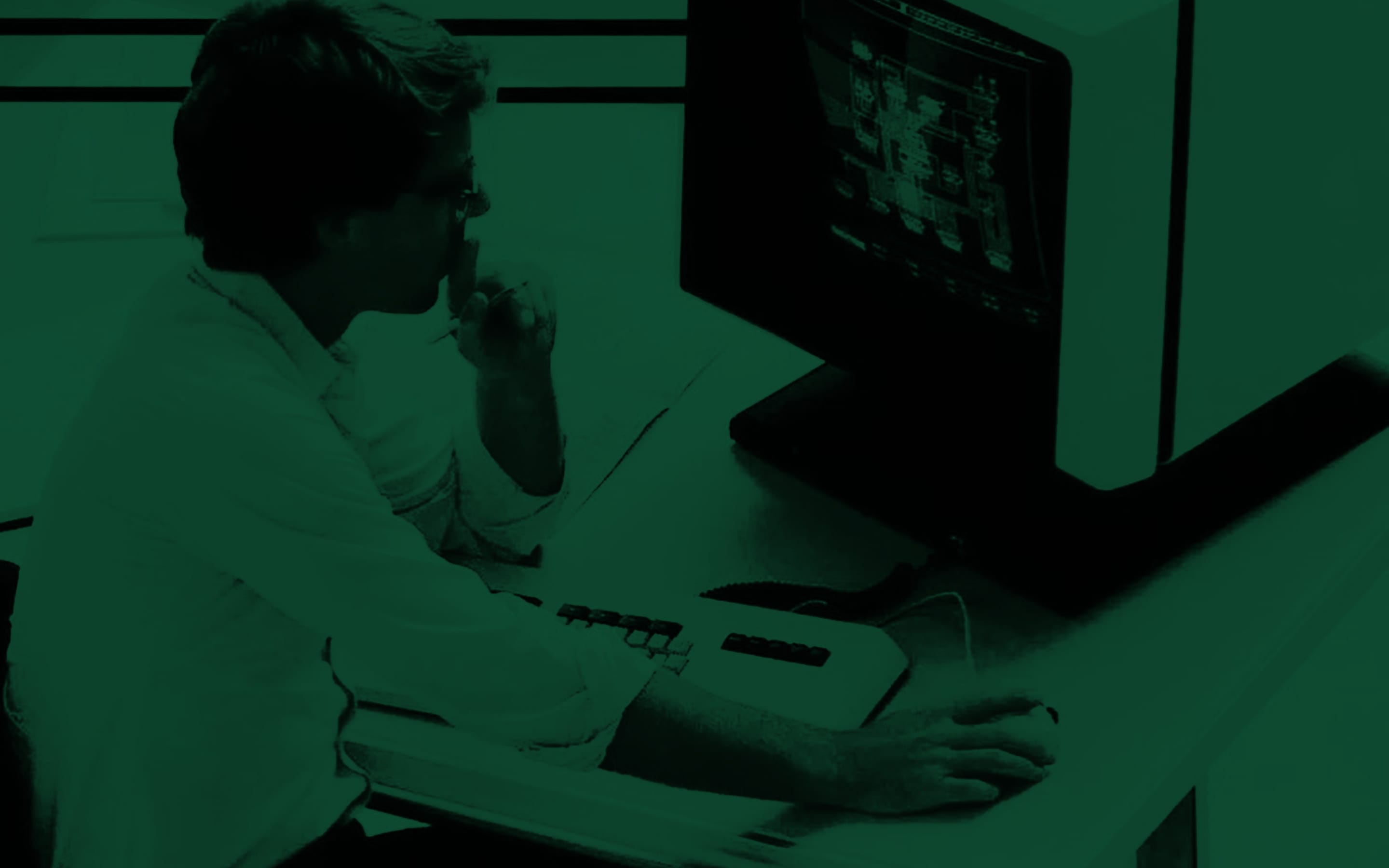 An engineer working at an early computer terminal